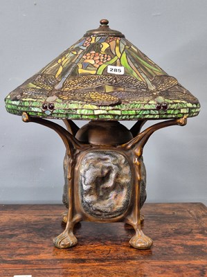 Lot 285 - A Tiffany taste bronze lamp with leaded glass...