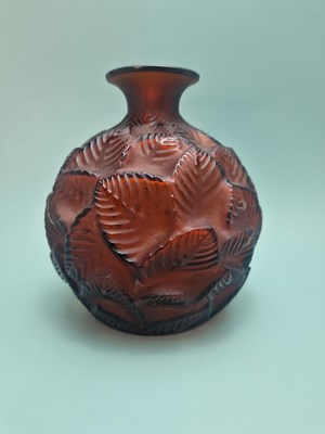 Lot 299 - A Lalique deep amber Feuilles Votive pattern...