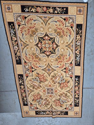 Lot 319 - Two floral needlework wool carpets or panels,...