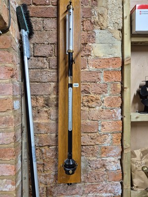 Lot 324 - A stick barometer and thermometer in and on a...