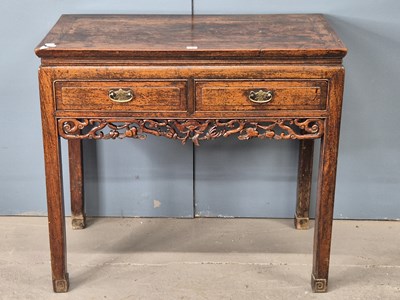 Lot 343 - A Chinese two drawer side table with a pierced...