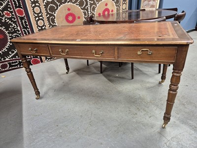 Lot 349 - A mahogany three drawer writing table with a...