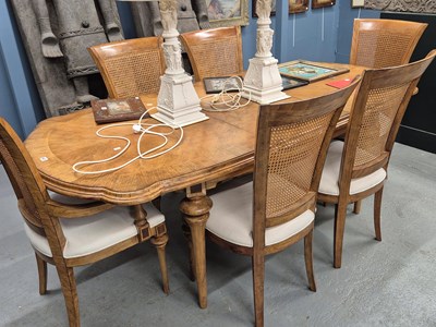 Lot 467 - A cross banded walnut dining table with...