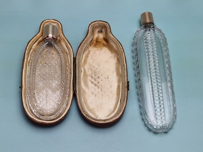 Lot 480 - A leather cased cut glass scent bottle with...