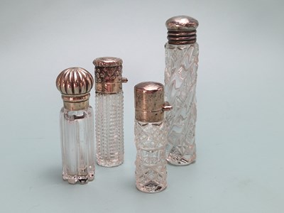 Lot 481 - Four cylindrical cut glass scent bottles with...