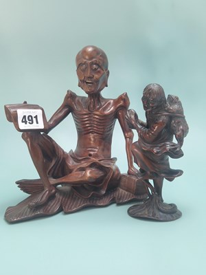 Lot 491 - A Chinese carved wood figure of Liu Hai...