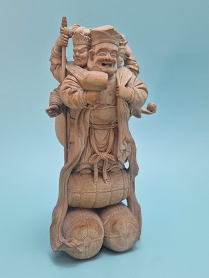 Lot 493 - A Japanese carved wood figure of the three...
