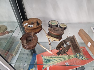 Lot 1636 - Three wooden fishing reels, another in brass,...