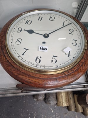 Lot 1655 - An oak cased wall clock