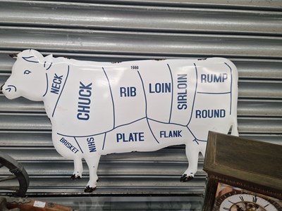 Lot 1666 - A butcher's cow shaped enamel sign showing the...