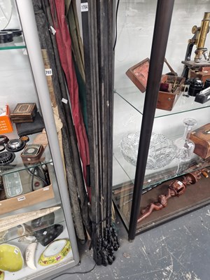 Lot 1704 - Ten Eastern ebonised wood curtain rails