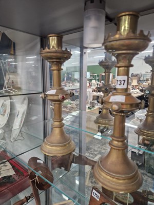 Lot 1737 - A pair of brass neogothic candlesticks the...