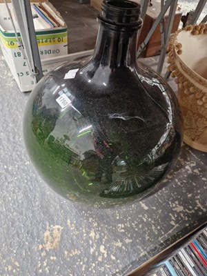 Lot 1760 - A green glass demijohn with its light fittings