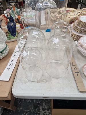 Lot 1819 - Six glass domes together with a glass cylinder