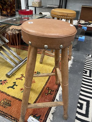 Lot 1826 - A pair of oak high stools with brown...