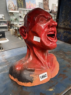 Lot 1862 - A red painted clay model of a male screaming head