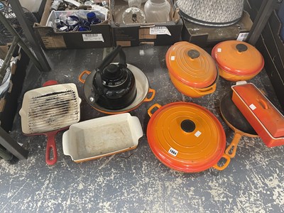 Lot 1884 - A collection of Le Creuset orange pots and pans