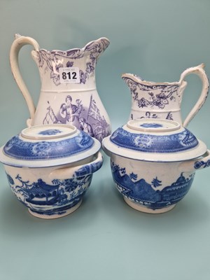 Lot 812 - A graded set of two mauve printed jugs...