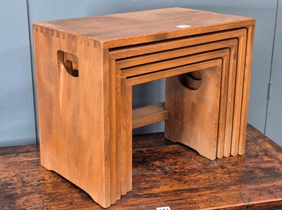 Lot 859 - A nest of five Ercol oak tables, the uppermost...