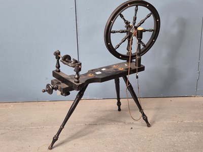 Lot 861 - A 19th century ebonised wood spinning wheel on...