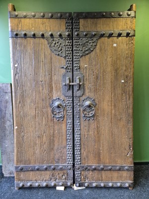 Lot 889 - A pair of pine doors bound by iron straps with...