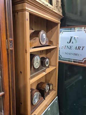 Lot 912 - A pine bookcase of three open shelves above a...