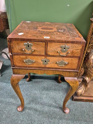 Lot 923 - A floral marquetried walnut chest of four...
