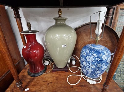 Lot 1003 - Three large pottery table lamps and a circular...