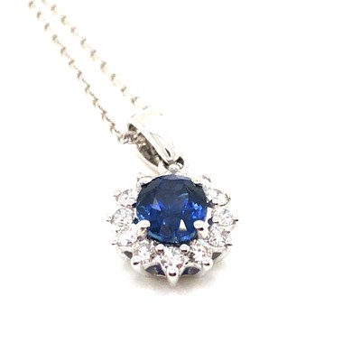Lot 21 - A sapphire and diamond cluster pendant...