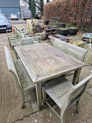 Lot 705 - A Vintage Weathered Teak garden table with two,...