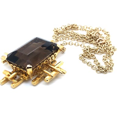 Lot 30 - A Brutalist style smokey quartz pendant...