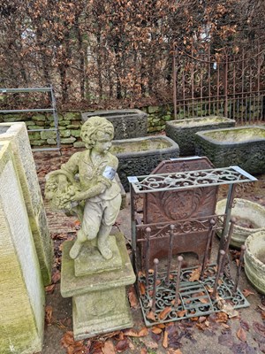 Lot 731 - An iron boot rack and a stoneware garden...