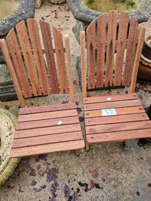 Lot 743a - A pair of teak folding patio chair.