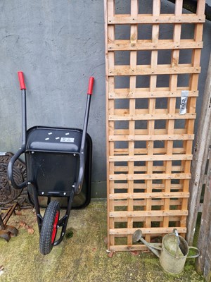 Lot 753 - An as-new wheelbarrow, two trellis panels 62 x...