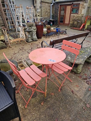 Lot 754a - A pink patio table and two chairs.