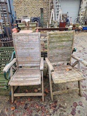 Lot 759 - Two teak folding patio chairs.