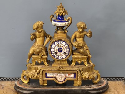 Lot 657 - A Victorian gilt metal-cased mantle clock with...