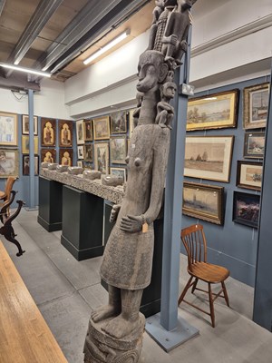 Lot 661 - An Adu guardian post carved with a lady with...