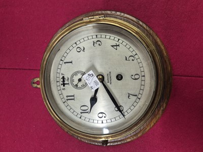 Lot 673 - A Vintage brass cased bulkhead clock with...