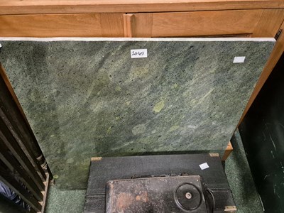 Lot 2045 - A mottled green stone slab.   66 x 65cms.