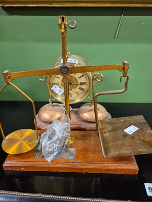 Lot 2058 - A brass cased mantel clock supported above two...