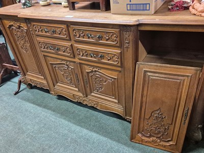 Lot 2069 - An oak side cabinet with central shell and...