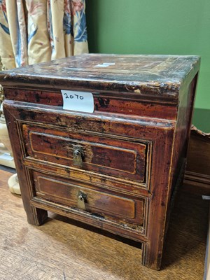 Lot 2070 - A Chinese mottled red two drawer cabinet.   W...
