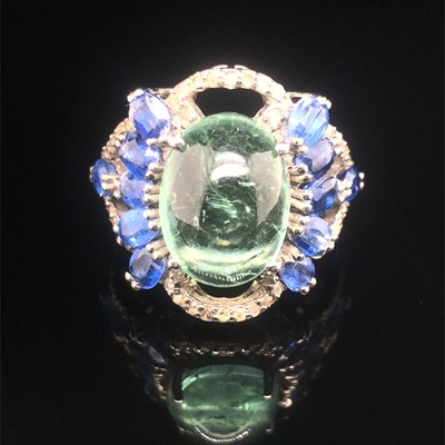 Lot 119 - A large cluster ring with an oval cabochon...