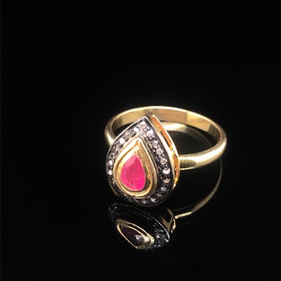 Lot 114 - A pear-shaped ring set with a pear-shaped ruby...
