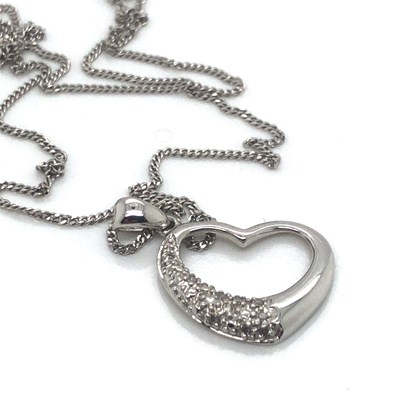 Lot 113 - A diamond set heart-shaped pendant. Diamond...