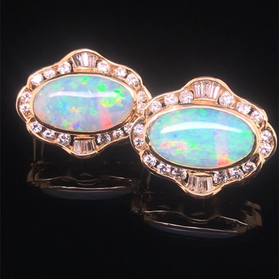 Lot 74 - A pair of opal and diamond large stud earrings...