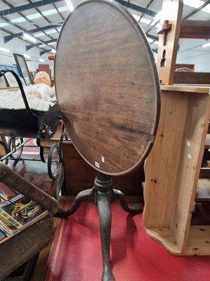Lot 1037 - A georgian mahogany tilt top tripod table.