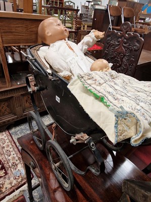 Lot 1039 - A vintage dolls pram and Two dolls.