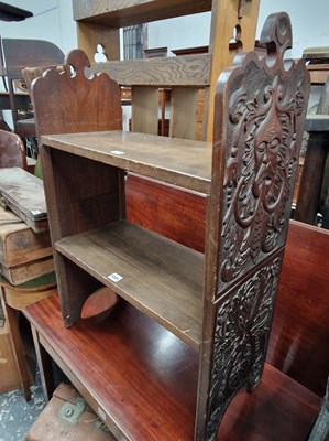 Lot 1041 - A carved oak small two tier book stand